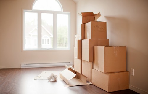 Local moving team handling boxes in an Ealing property