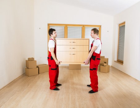 Movers navigating stairs and access challenges in an Ealing property